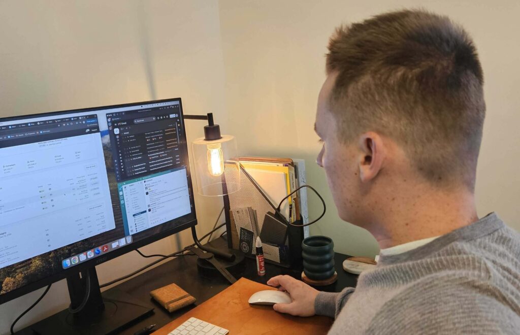 Man at a diagonal angle working on email marketing on a computer screen